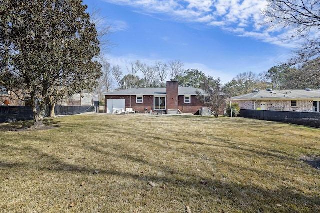 rear view of property with a yard