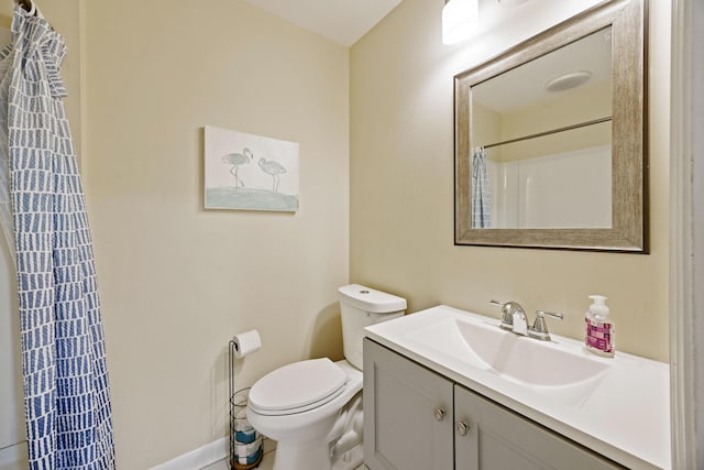 bathroom with vanity, curtained shower, and toilet