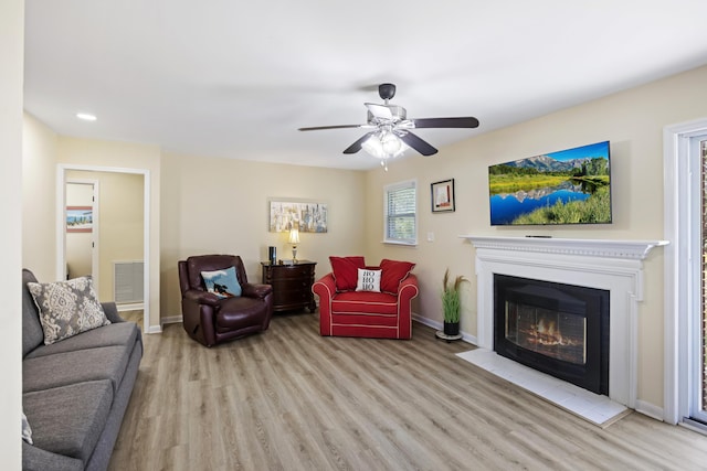 living room featuring ceiling fan and light wood-type flooring