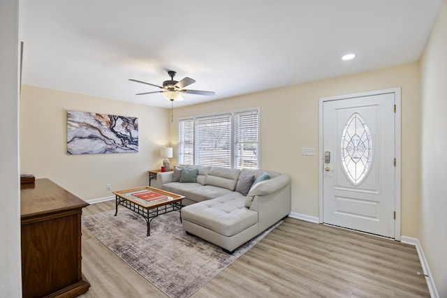 living room with ceiling fan and light hardwood / wood-style flooring