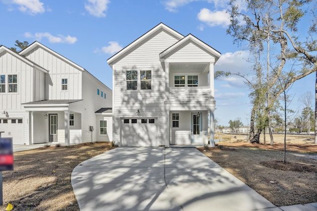 view of front of house with a garage, board and batten siding, a balcony, covered porch, and driveway