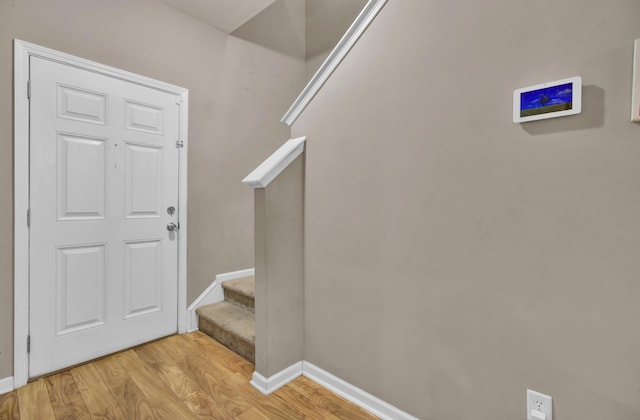 staircase featuring hardwood / wood-style flooring