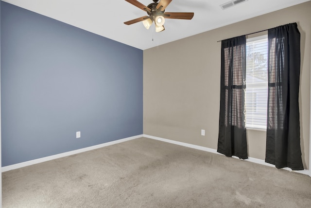 carpeted spare room featuring ceiling fan