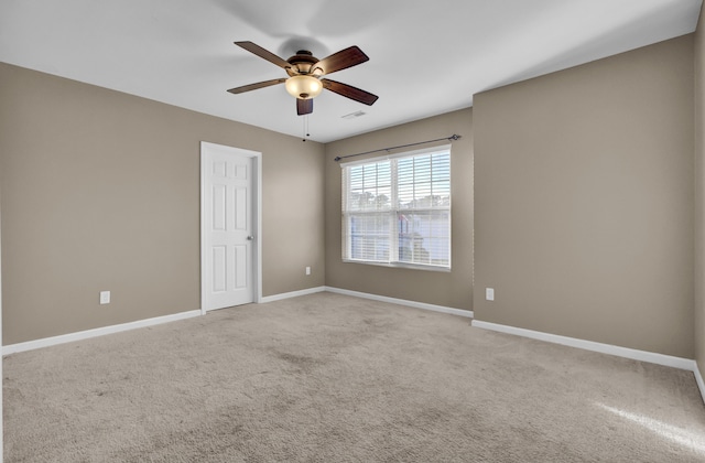 unfurnished room with ceiling fan and light colored carpet