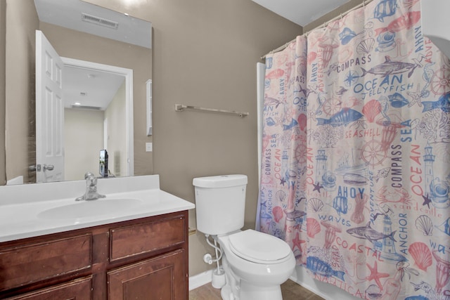 bathroom featuring toilet, vanity, and a shower with shower curtain