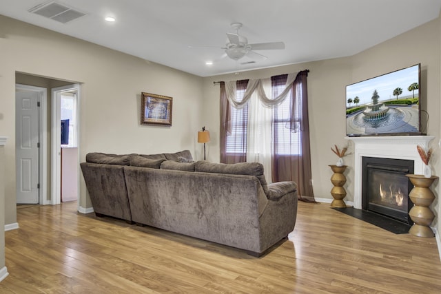 living room with ceiling fan and light hardwood / wood-style floors