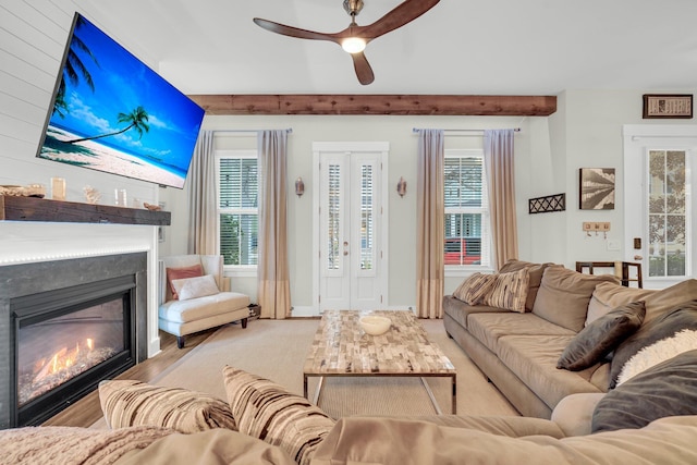 living room with beamed ceiling, ceiling fan, and french doors