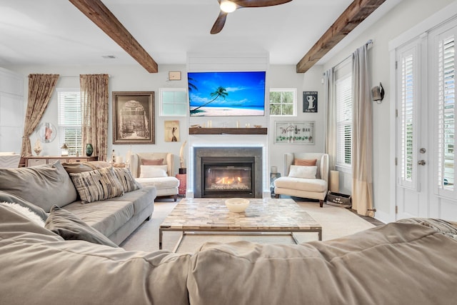 living room featuring ceiling fan and beam ceiling