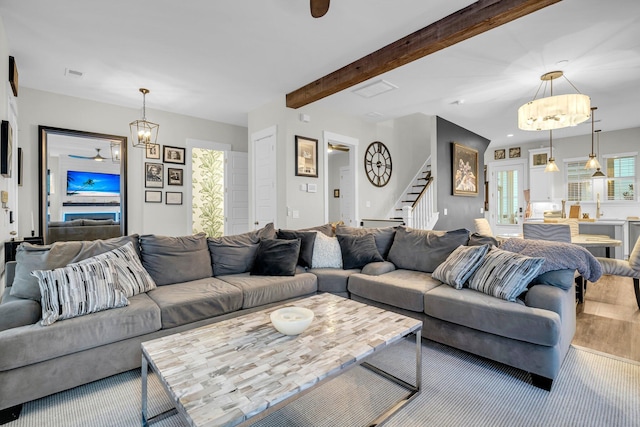 living room featuring sink, beam ceiling, and carpet floors