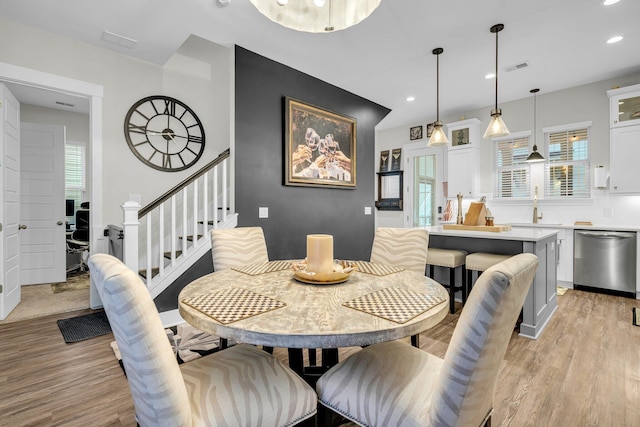 dining room featuring sink and light hardwood / wood-style floors