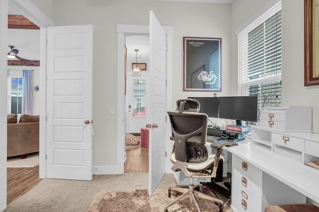 office area with light colored carpet and a healthy amount of sunlight