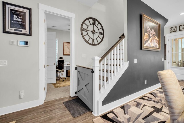 stairway with hardwood / wood-style flooring