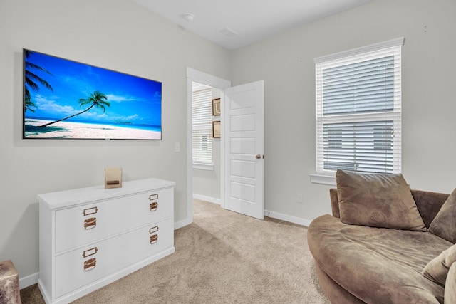 sitting room featuring light carpet and plenty of natural light