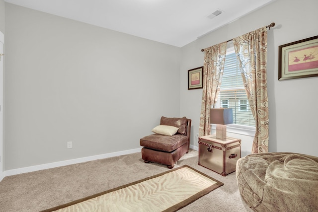 living area featuring a healthy amount of sunlight and light colored carpet