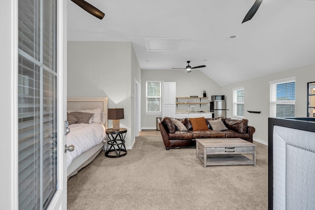 living room with ceiling fan, vaulted ceiling, and light carpet