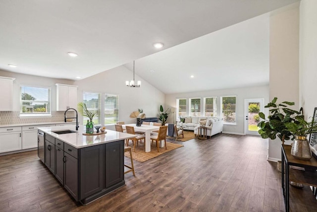 453 White Magnolia St, Moncks Corner, SC 29461 - kitchen featuring a sink, vaulted ceiling, white cabinets, light countertops, and dark wood finished floors