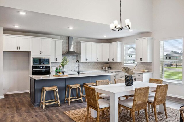 453 White Magnolia St, Moncks Corner, SC 29461 - kitchen featuring wall chimney exhaust hood, wall oven, a chandelier, white cabinetry, and recessed lighting