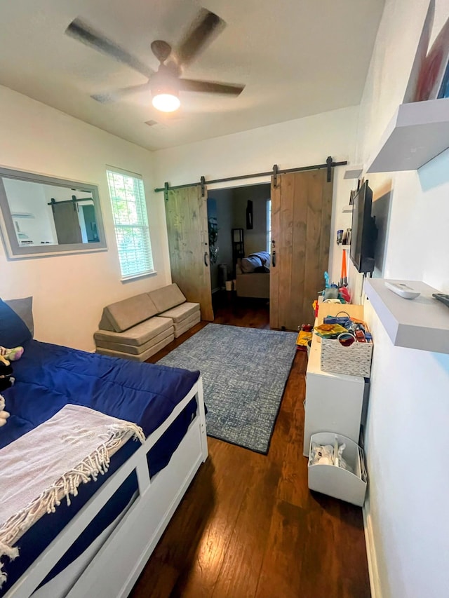 1418 Whispering Oak Trl, Mount Pleasant, SC 29466 - bedroom with a barn door, wood finished floors, and a ceiling fan