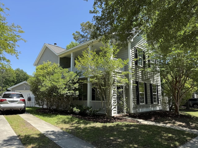 1418 Whispering Oak Trl, Mount Pleasant, SC 29466 - view of front facade featuring a balcony, a front lawn, and covered porch