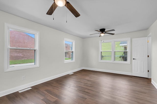 empty room featuring ceiling fan and dark hardwood / wood-style floors