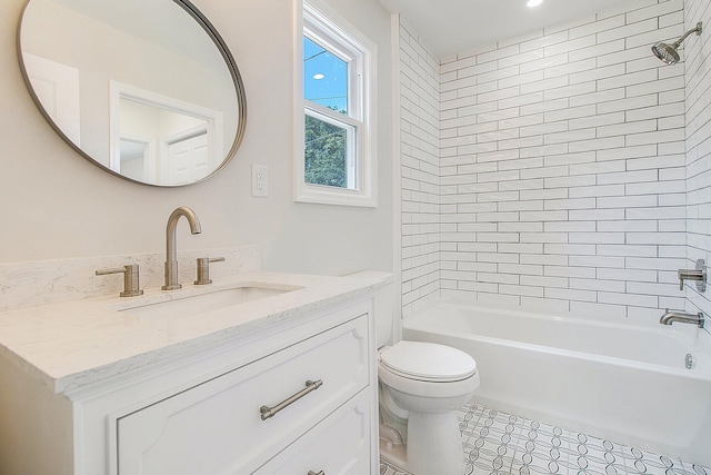 full bathroom featuring toilet, tiled shower / bath combo, and vanity