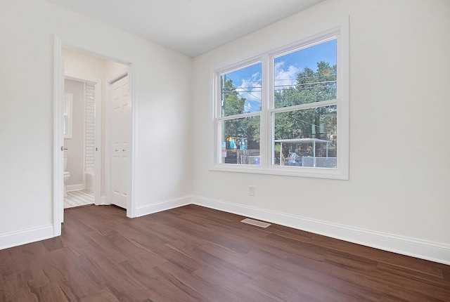 spare room with dark hardwood / wood-style flooring