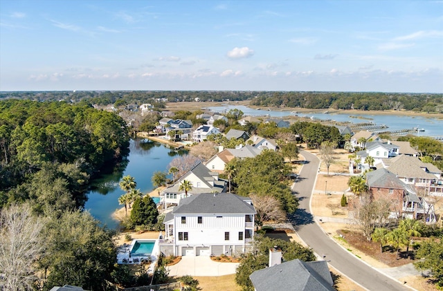 drone / aerial view featuring a water view and a residential view