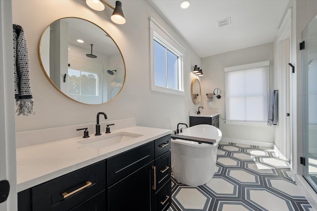 full bathroom with recessed lighting, visible vents, a sink, and a shower stall