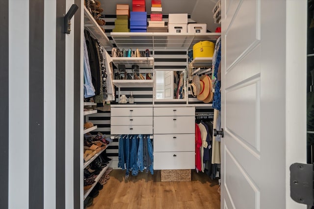 walk in closet with wood finished floors