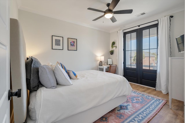 bedroom featuring visible vents, access to outside, french doors, light wood-type flooring, and crown molding