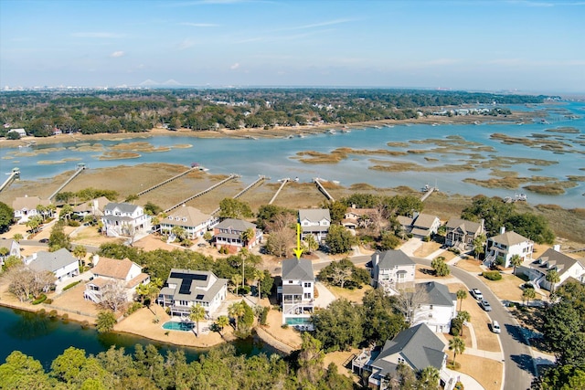 birds eye view of property with a residential view and a water view