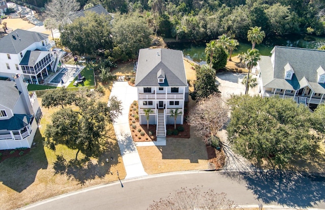 drone / aerial view with a water view and a residential view