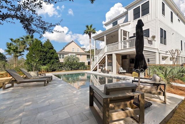 pool featuring a patio area and stairway