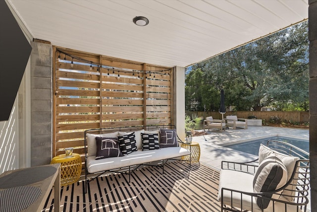 view of patio / terrace with an outdoor hangout area and fence