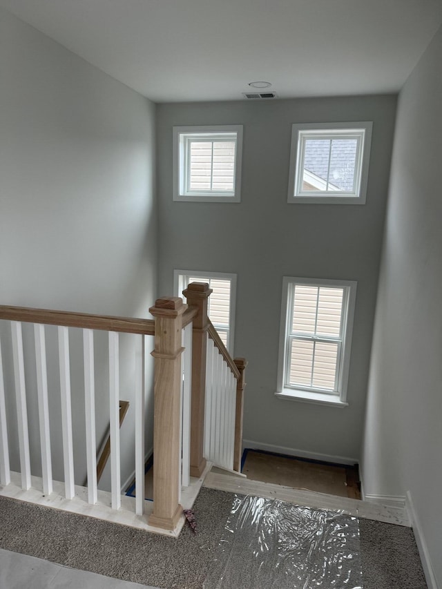 unfurnished living room featuring ceiling fan and a wealth of natural light