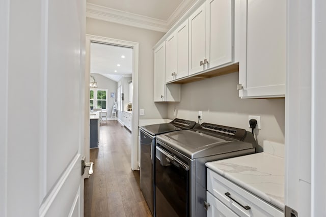 washroom with cabinet space, independent washer and dryer, dark wood-style flooring, ornamental molding, and recessed lighting