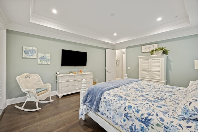 bedroom with a raised ceiling, dark wood finished floors, crown molding, recessed lighting, and baseboards