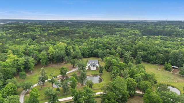 aerial view of property and surrounding area with a forest