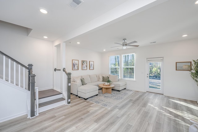 living room with ceiling fan and light hardwood / wood-style floors