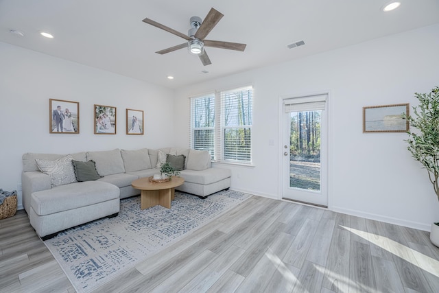 living room featuring ceiling fan and light hardwood / wood-style flooring