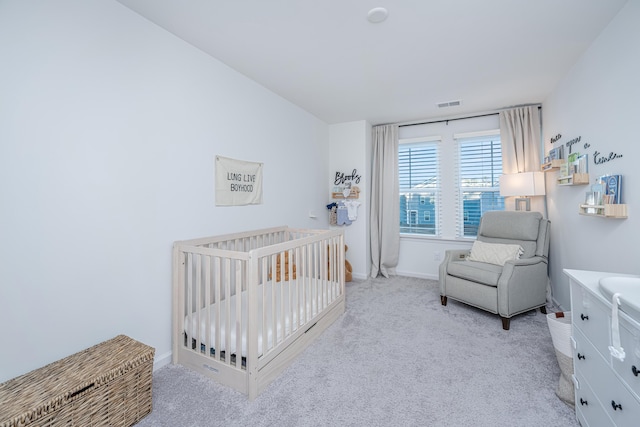 carpeted bedroom with a crib