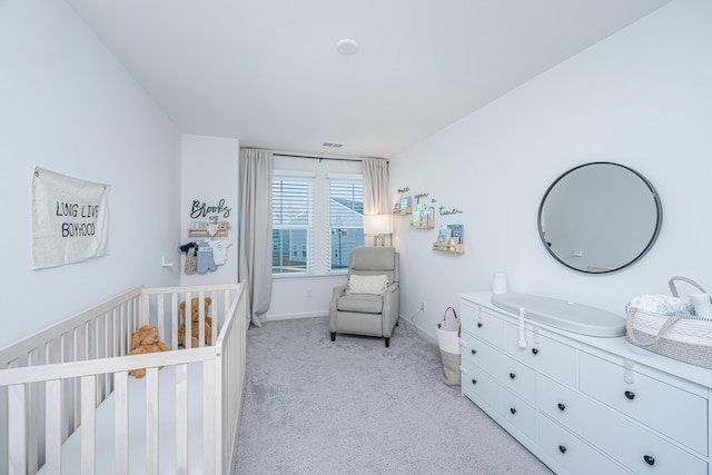 carpeted bedroom with a crib