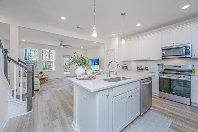 kitchen with sink, white cabinetry, and stainless steel appliances