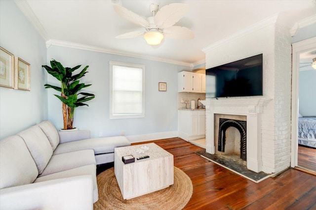 living room featuring ceiling fan, a fireplace, dark wood-type flooring, brick wall, and ornamental molding