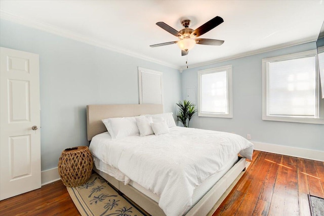 bedroom with crown molding, dark hardwood / wood-style floors, and ceiling fan