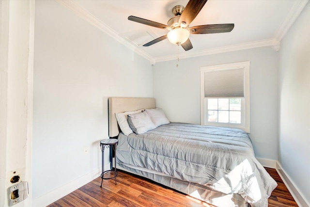 bedroom featuring dark hardwood / wood-style floors, ceiling fan, and crown molding