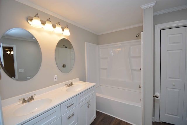 bathroom with hardwood / wood-style flooring, vanity, ornamental molding, and shower / bath combination