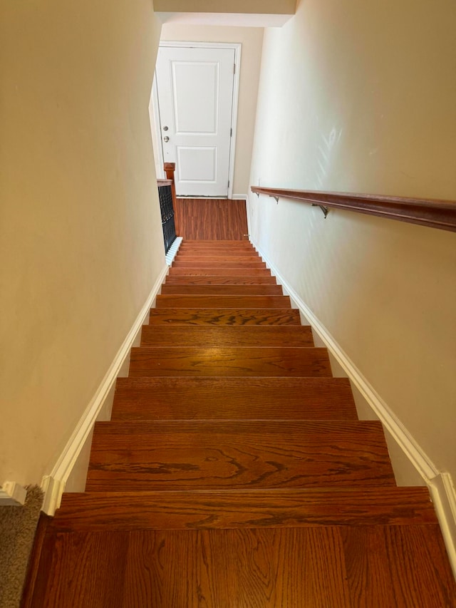 stairs with hardwood / wood-style flooring