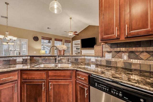 kitchen with stainless steel dishwasher, sink, dark stone countertops, pendant lighting, and lofted ceiling