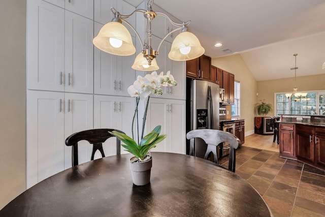 dining room featuring a chandelier and lofted ceiling